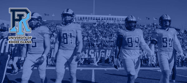 Football players walking on a field with 'University of Rhode Island' logo.